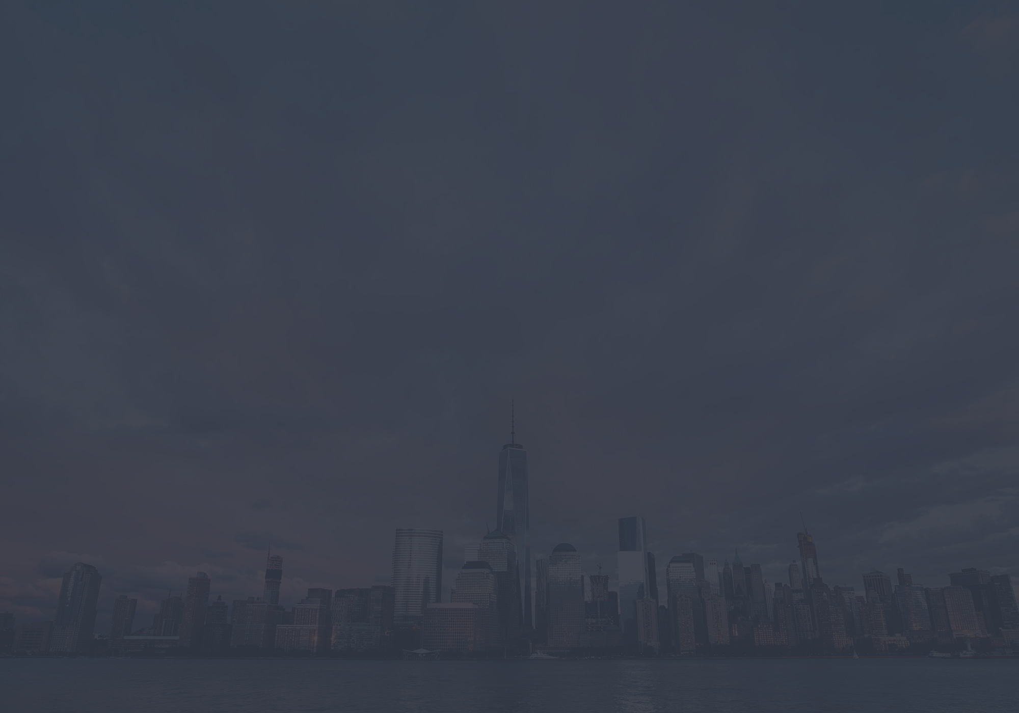 New York City skyline at dusk with One World Trade Center.