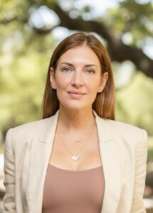 Professional woman posing outdoors with a confident smile. Professional woman posing outdoors with a confident smile.
